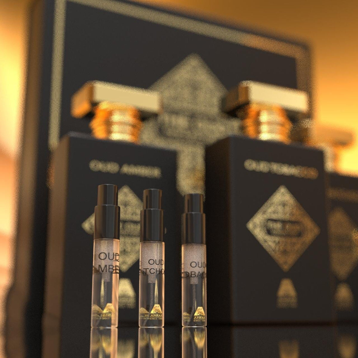 Black and gold oud perfume bottles and sample vials displayed in front of an ornate gift box