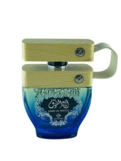 Blue glass Ajyad Areej Al Shouq perfume bottle with a light-colored wooden block cap and side strap.