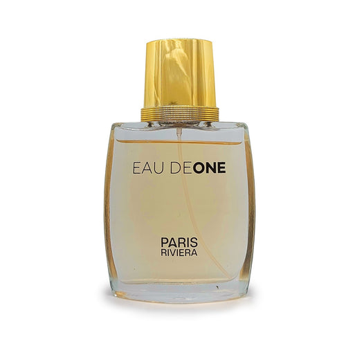 Eau de One Paris Riviera perfume bottle with clear glass, amber liquid, and a ribbed gold cap.