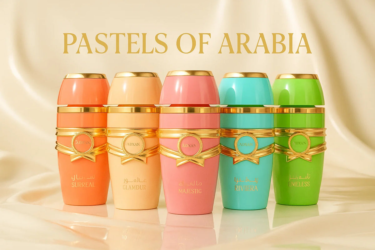 Five colorful Adxan perfume bottles: Surreal, Glamour, Majestic, Riviera, and Timeless with gold accents