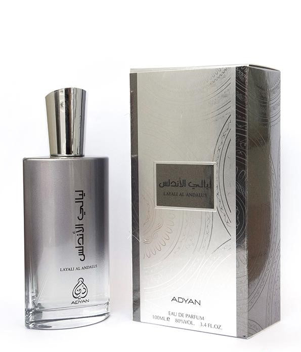 Silver Adyan Layali Al Andalus perfume bottle next to its matching silver and grey patterned box.