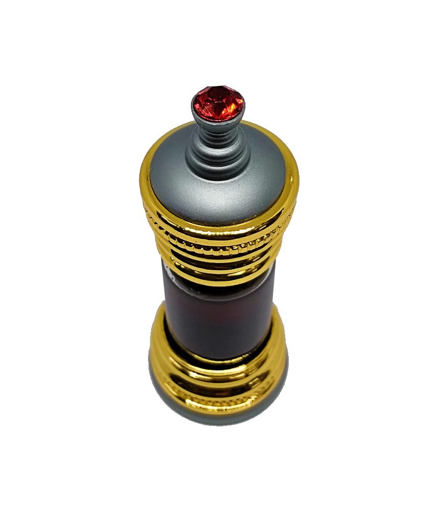 Ornate gold and silver Anfar perfume bottle containing dark brown perfume oil, topped with a small red jewel.