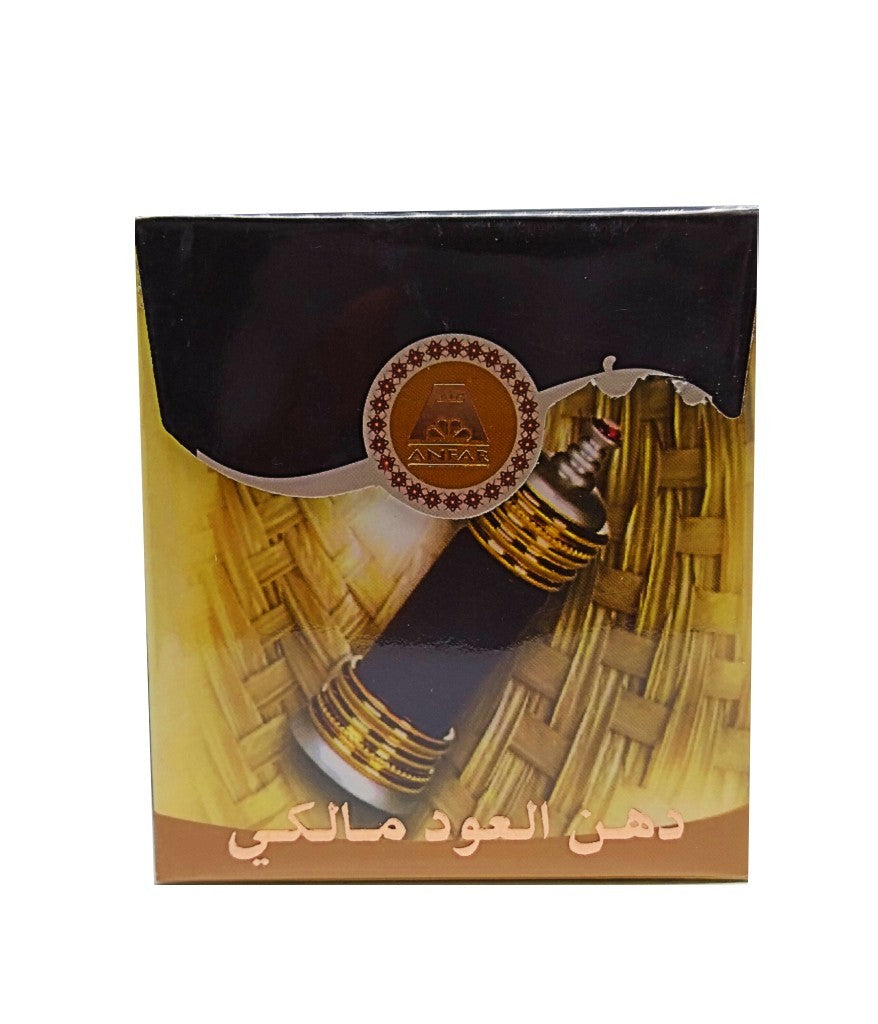 Ornate gold and silver Anfar perfume bottle containing dark brown perfume oil, topped with a small red jewel.