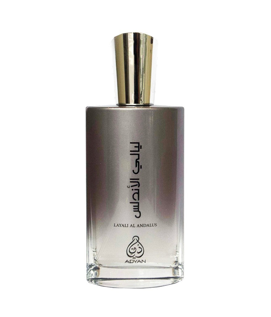 Adyan Layali Al Andalus perfume bottle. Metallic gray gradient glass, gold cap, and Arabic calligraphy.