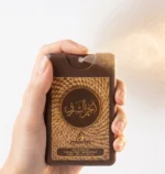 Hand spraying Anjam Al Sharq 20ml travel size pocket perfume, unisex oud fragrance by Ard Al Oud