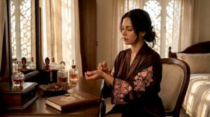 Woman applying perfume at marble vanity